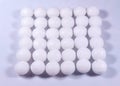 A square shaped pile of white naphthalene balls.