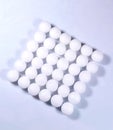 A square shaped pile of white naphthalene balls.