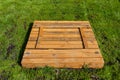 A square-shaped playground made of a wooden closed box, the box is closed. Royalty Free Stock Photo