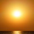 Orange sunset in blur over the sea. Beautiful monochrome background Royalty Free Stock Photo