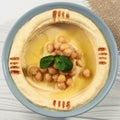 Square shot of Top view of hummus plate on wooden table Royalty Free Stock Photo