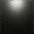A square slate surface with a smooth, dark texture, surrounded by slightly rough, uneve Royalty Free Stock Photo