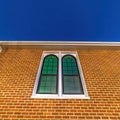 Square Sliding arched glas windows of a church in provo Utah against brick wall