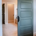 Square Sliding gray wooden panel door that leads to the bathroom of a home Royalty Free Stock Photo