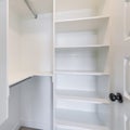 Square Small walk in closet with white interior and carpeted flooring