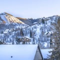 Square Snowed in mountain in Park City during winter with homes under overcast sky