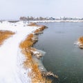 Square Snowy bridge overlooking a calm silvery lake amid a frosty landscape in winter