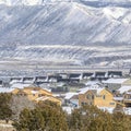 Square Snowy mountain and aerial view of houses in Utah Valley neighborhood in winter Royalty Free Stock Photo