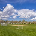 Square Soccer field and baseball field with view of mountain and cloudy blue sky Royalty Free Stock Photo