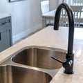 Square Stainless steel undermount double basin kitchen island sink with black faucet Royalty Free Stock Photo