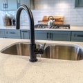 Square Stainless steel undermount kitchen island sink with double bowl and black faucet Royalty Free Stock Photo