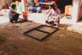 Square steel framing, external welding, ironworker, construction, worker using a steel cutter of the workpiece to be welded on the Royalty Free Stock Photo