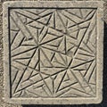 Square stone tile with engraved geometric pattern Royalty Free Stock Photo