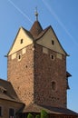 Square stone tower in the ancient Loket Castle under the blue sky at summer. Bohemia, Sokolov, Karlovarsky Region, Czech Republic