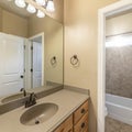 Square Sun flare Master bathroom with light brown theme color and white doors Royalty Free Stock Photo