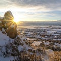 Square Sunrise in snowy Utah Valley with cloudy sky over lake homes and mountain