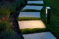 Square tile marble path illuminated by a lantern.