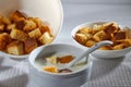 Square toasted pieces of homemade delicious rusk, hardtack, Dryasdust, zwieback and plate of milk on a white tablecloth