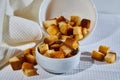 Square toasted pieces of homemade delicious rusk, hardtack, Dryasdust, zwieback in a plate on a white tablecloth