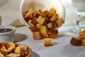 Square toasted pieces of homemade delicious rusk, hardtack, Dryasdust, zwieback in a plate on a white tablecloth