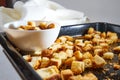 Square toasted pieces of homemade delicious rusk, hardtack, Dryasdust, zwieback on a white plate and baking sheet