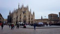 Square with tourists near Duomo di Milano cathedral, Italian gothic architecture