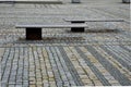 colored cobblestone cube tiles of gray brown and black color laid in rows on the square. It creates the impression giant mosaic