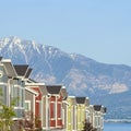 Square Townhouses exterior with scenic lake and snowy steep mountain background