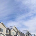 Square Townhouses on a residential neighborhood landscape with cloudy sky background