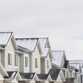 Square Townhouses with snowy gable roofs in South Jordan Utah on a cloudy winter day