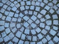 Square treated stones are laid out around. Fragment of the cobblestone square in the park Royalty Free Stock Photo