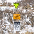 Square Various trail signs and dog leash sign on an old wooden post Royalty Free Stock Photo