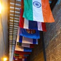 Square Vibrant colorful decorative flags against corrugated metal roof of building