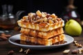 Square waffles with baked apples and nuts with honey on a plate