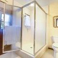 Square Walk in shower in southern california home with warm lightling and exit door