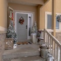 Square Wet stairs at home entrance leading to front door with christmas tree and wreath Royalty Free Stock Photo