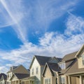 Square Whispy white clouds Cirrus clouds against the vivid blue sky over the residential houses at Daybreak, Utah Royalty Free Stock Photo