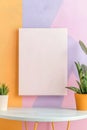 Square white canvas on pastel retro background with plants on table Royalty Free Stock Photo