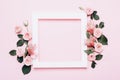 Square white frame and pink roses on pink background. Beautiful flower arrangement for your design Royalty Free Stock Photo