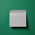 A square white note paper is placed on a plain green textured background. The top e Royalty Free Stock Photo