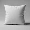Square white pillow on a plain, neutral background. The pillow features smooth, clean Royalty Free Stock Photo
