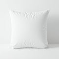 A square white pillow with a smooth, plain texture placed against a light gray background.