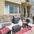 Square White puffy clouds Patio of a townhouse with woven set of couch and armchairs