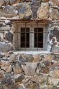 Square window on a brick wall with bars Royalty Free Stock Photo