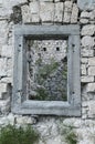 Square window in a stony wall of old ruins in Slovenia Royalty Free Stock Photo