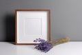 Square wooden frame mockup for artwork, photo, print and painting presentation with dry lavender flowers Royalty Free Stock Photo