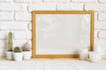 Square wooden photo frame and cactus plants on the table Royalty Free Stock Photo