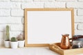 Square wooden photo frame and cactus plants on the table Royalty Free Stock Photo