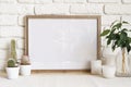 Square wooden photo frame and cactus plants on the table Royalty Free Stock Photo