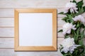 Square wooden picture frame mockup with pale pink peony